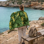 Person standing near water wearing rainforest microfibre beach towel, lightweight quick dry travel towel