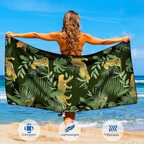 Woman holding rainforest microfibre beach towel open on beach, large quick dry sand free towel