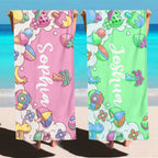Child walking on beach wearing personalised microfibre towel with name, kids quick dry beach towel