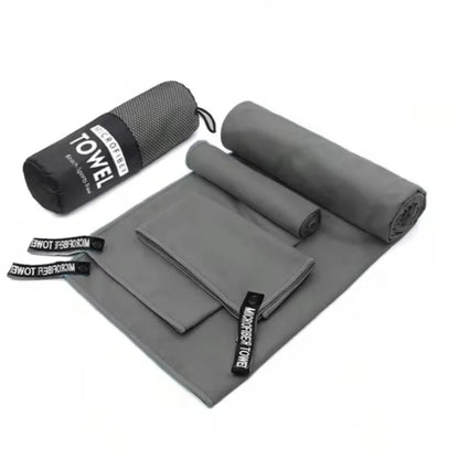 Complete 3-piece Dark Grey microfibre towel set laid flat, showing all three sizes and the matching carry bag.