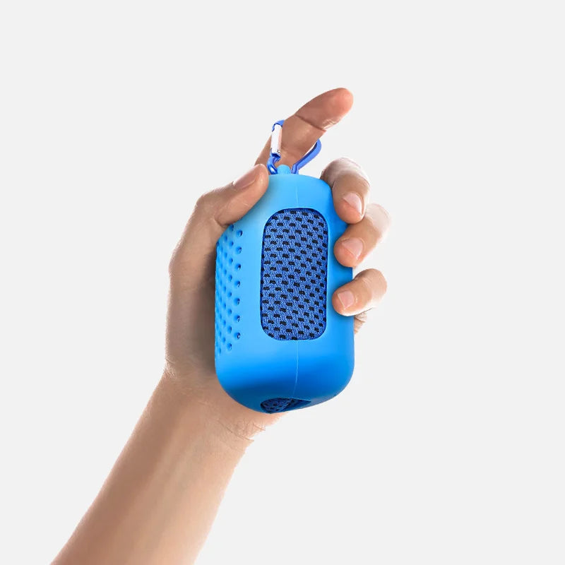 Hand holding cooling towel with silicone case, lightweight portable cooling towel
