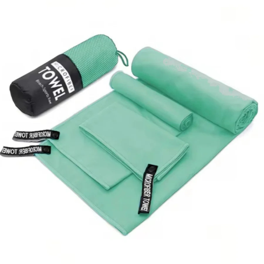 Complete 3-piece Mint Green microfibre towel set laid flat, showing all three sizes and the matching carry bag.