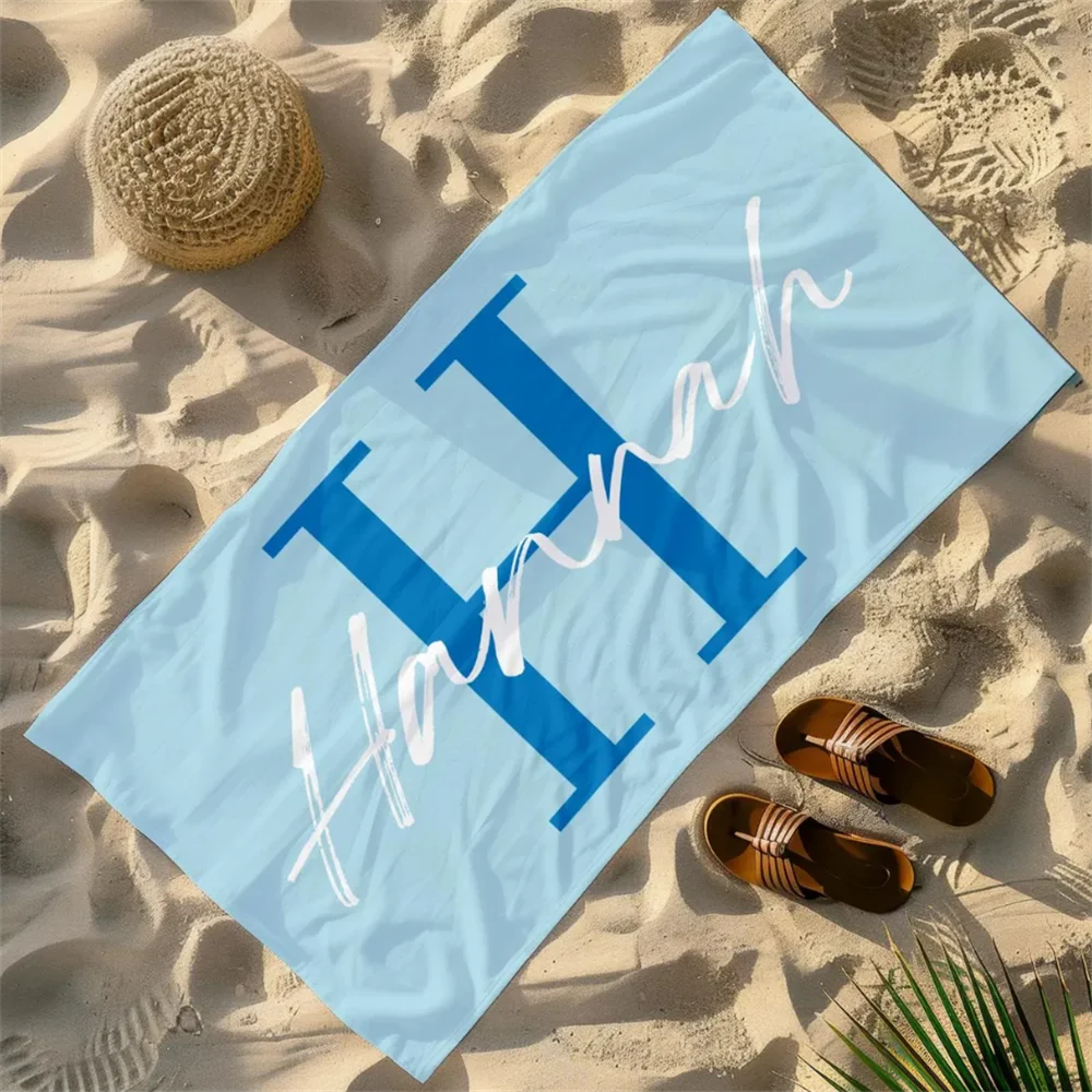 blue personalised microfibre beach towel with large letter and name
