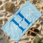 blue personalised microfibre beach towel with large letter and name