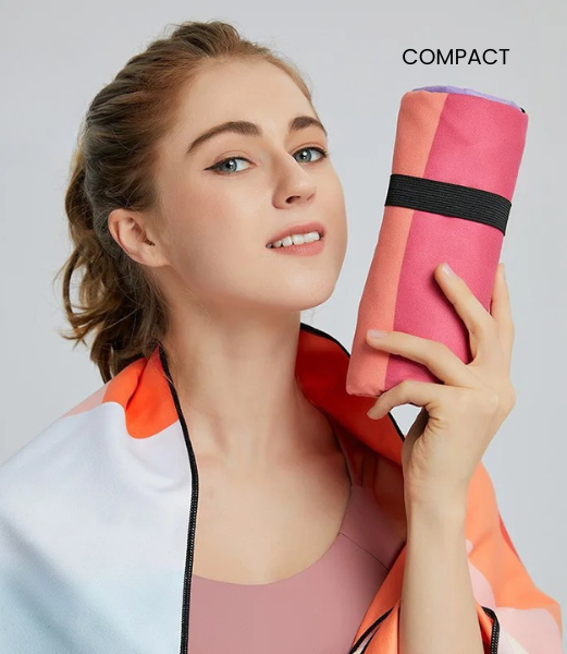 woman holding compact rolled velvet microfibre towel portable towel
