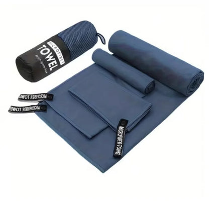Complete 3-piece Navy Blue microfibre towel set laid flat, showing all three sizes and the matching carry bag.