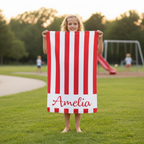 Child wrapped in personalised striped towel with name, soft microfibre beach towel